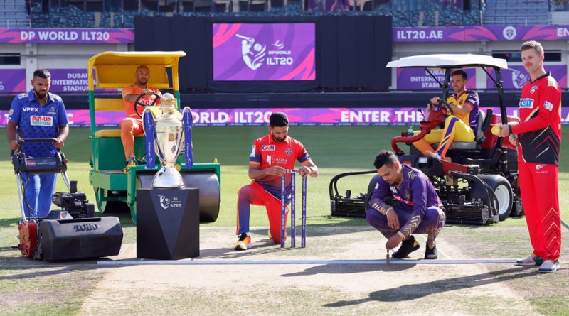 DP World ILT20 players pose with the tournament trophy at the Dubai International Stadium turf